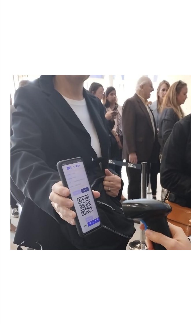 Staff scanning an attendee's QR code to validate room entry